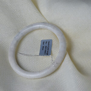 Authentic natural jade bangle in light white tone with delicate stone veins, polished finish, close-up product photo